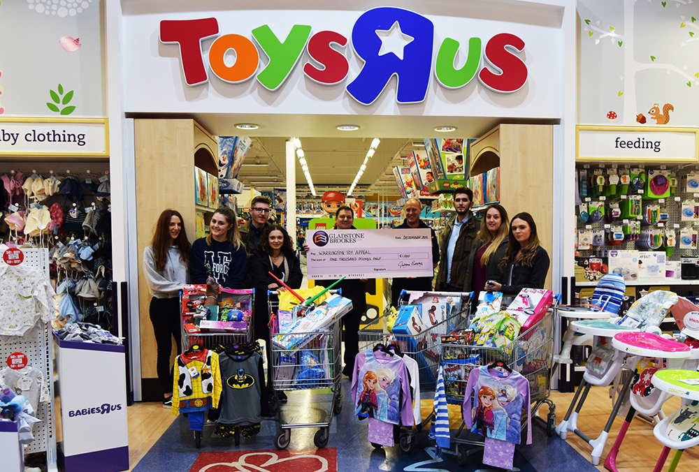 Our eight volunteers pictured with appeal organiser Paul Whittaker (centre back row) after their £1,100 trolley dash around Toys ‘R’ Us